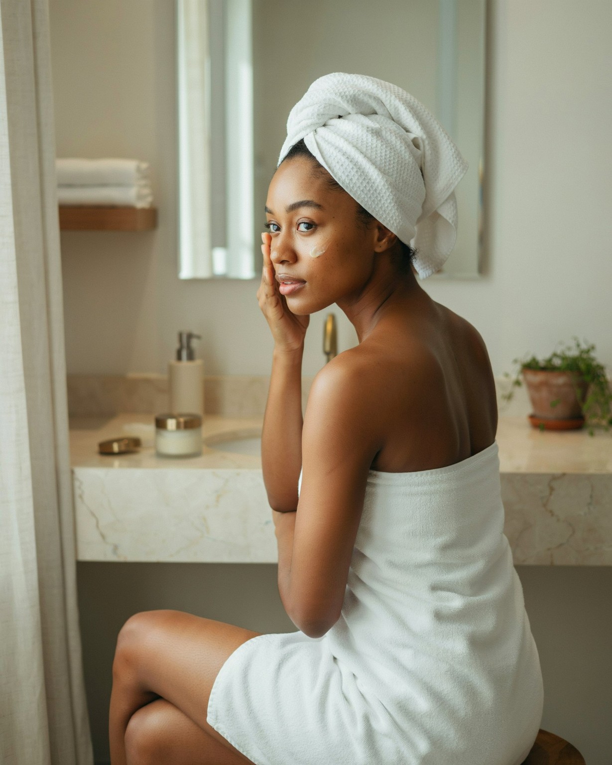 A woman with warm medium-brown skin in a natural beauty portrait
